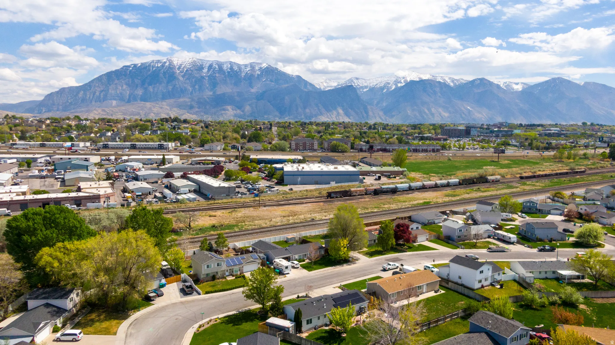 Aerial view of residential area featuring a mountainous background