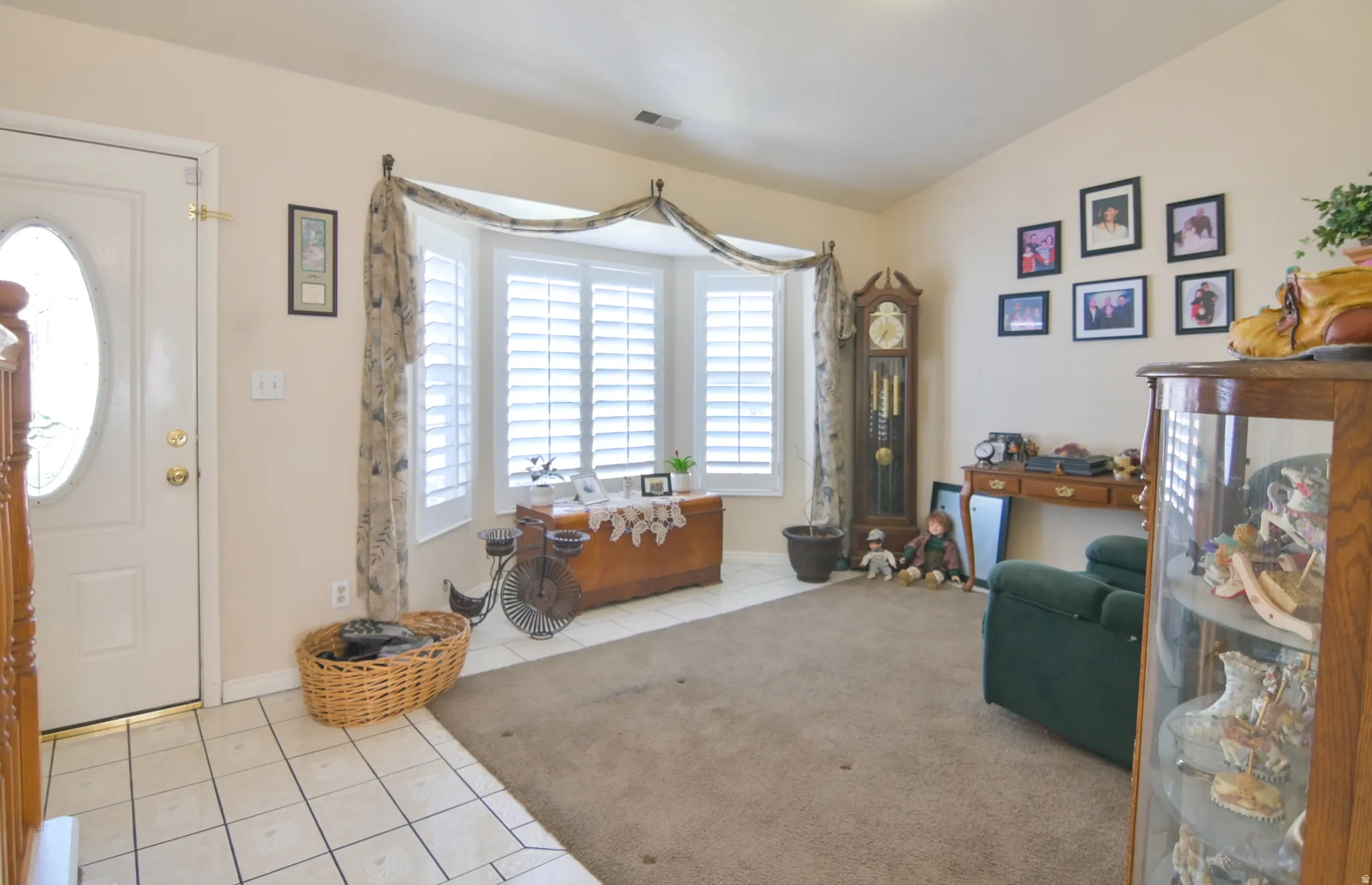 Entryway featuring light tile patterned flooring and vaulted ceiling