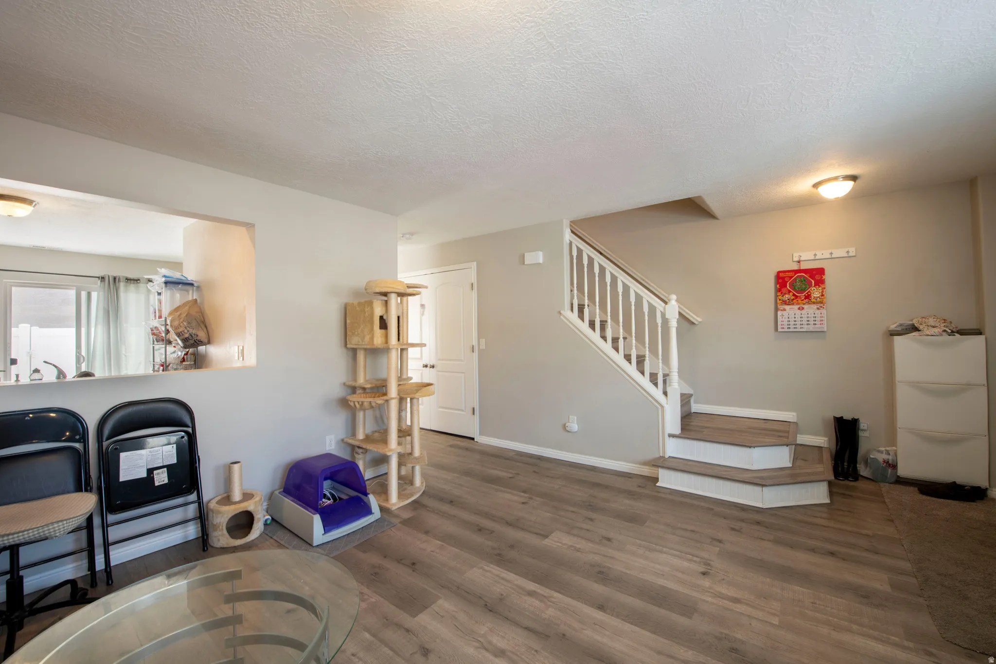Living area with wood finished floors and a textured ceiling