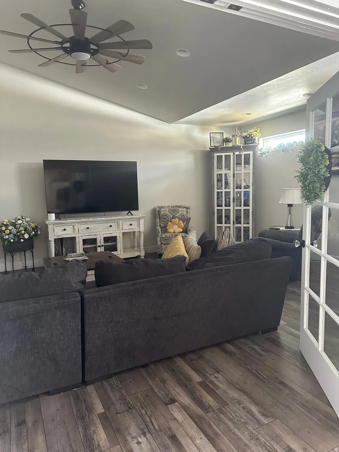Living area featuring ceiling fan, hardwood / wood-style floors, and vaulted ceiling