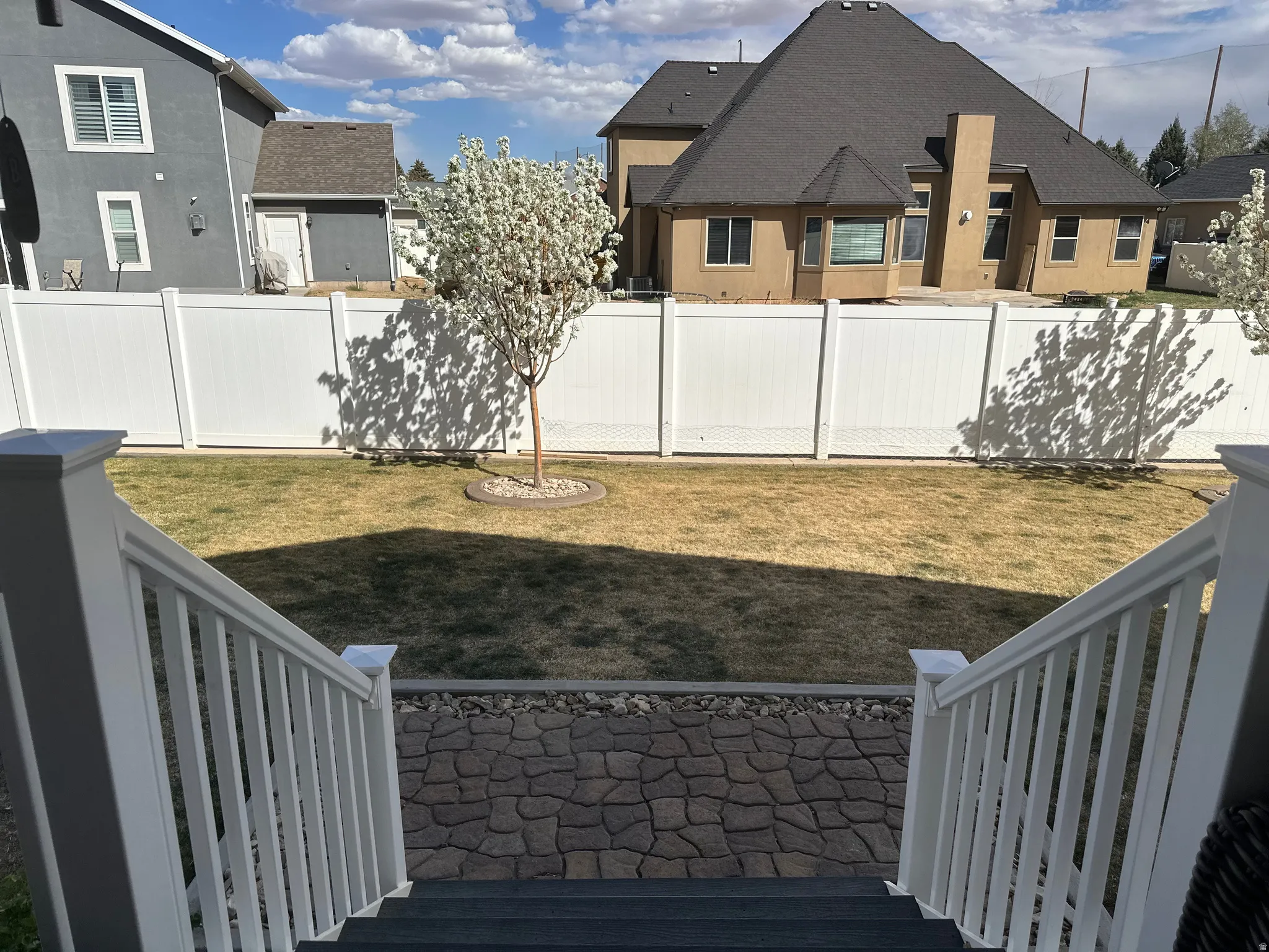 Fenced backyard with a wooden deck and a residential view