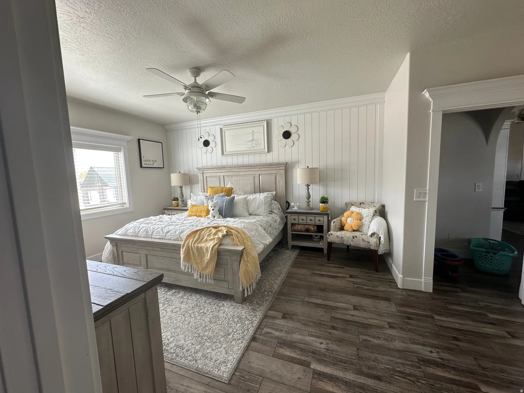 Bedroom featuring dark wood finished floors, a textured ceiling, and a ceiling fan