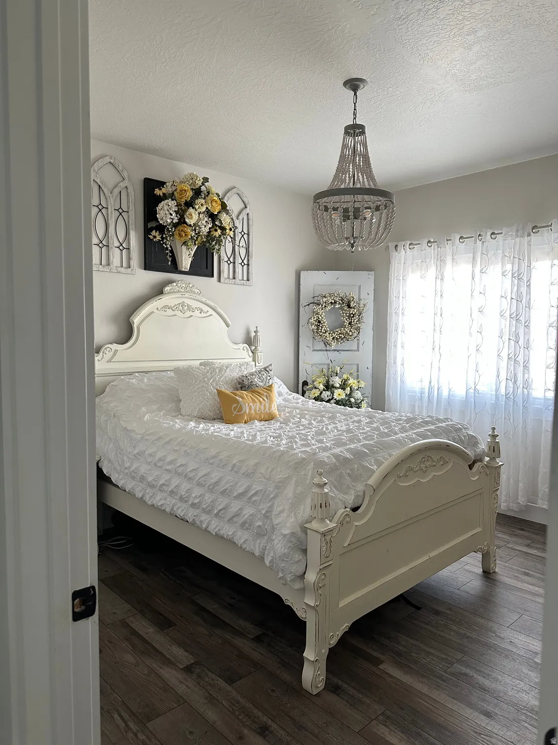 Bedroom with dark wood-type flooring and a textured ceiling