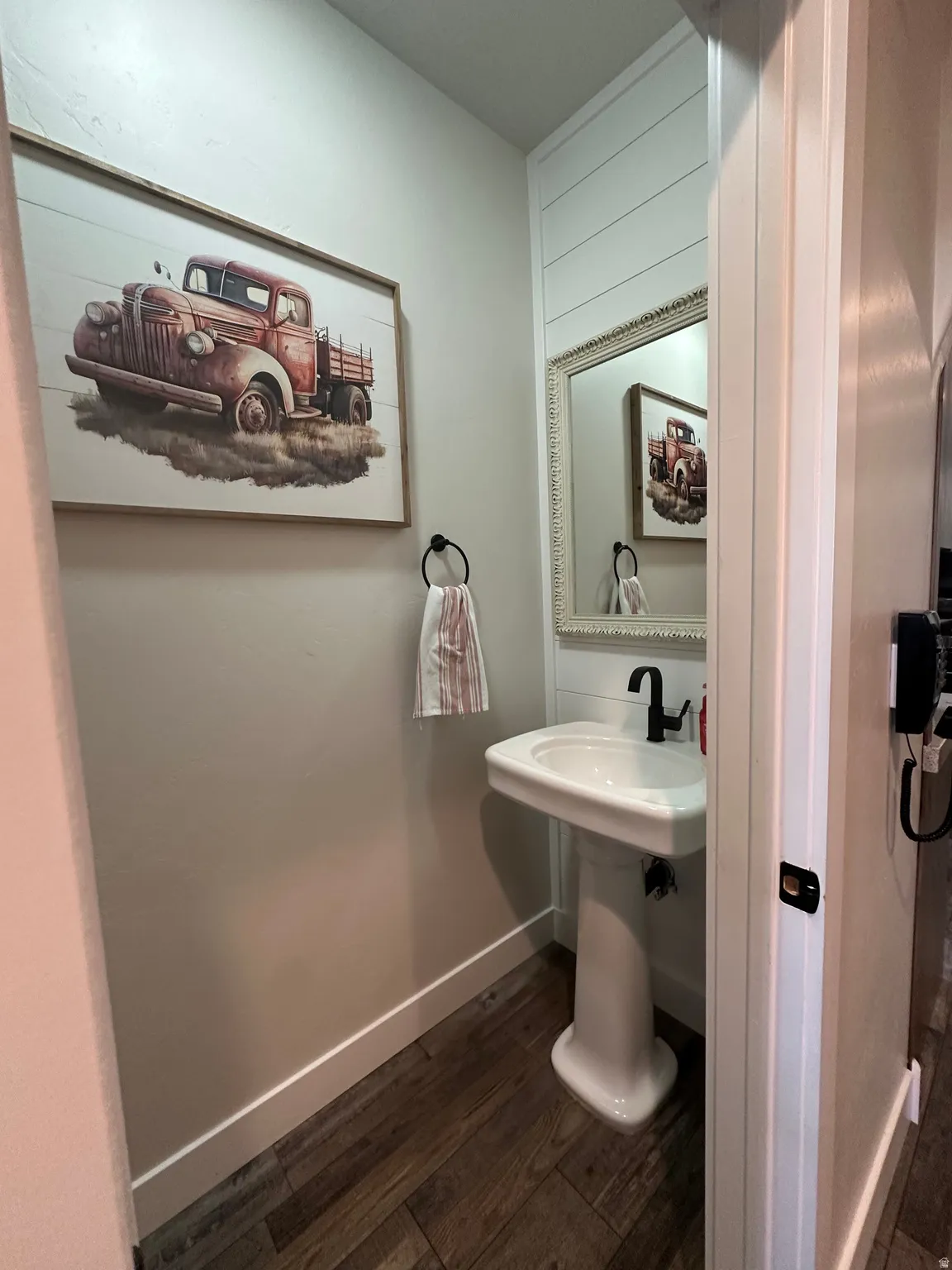 Bathroom with dark wood finished floors and baseboards