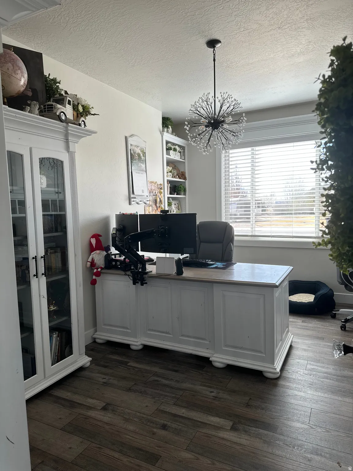 Home office featuring dark wood finished floors, a textured ceiling, and suspended lighting