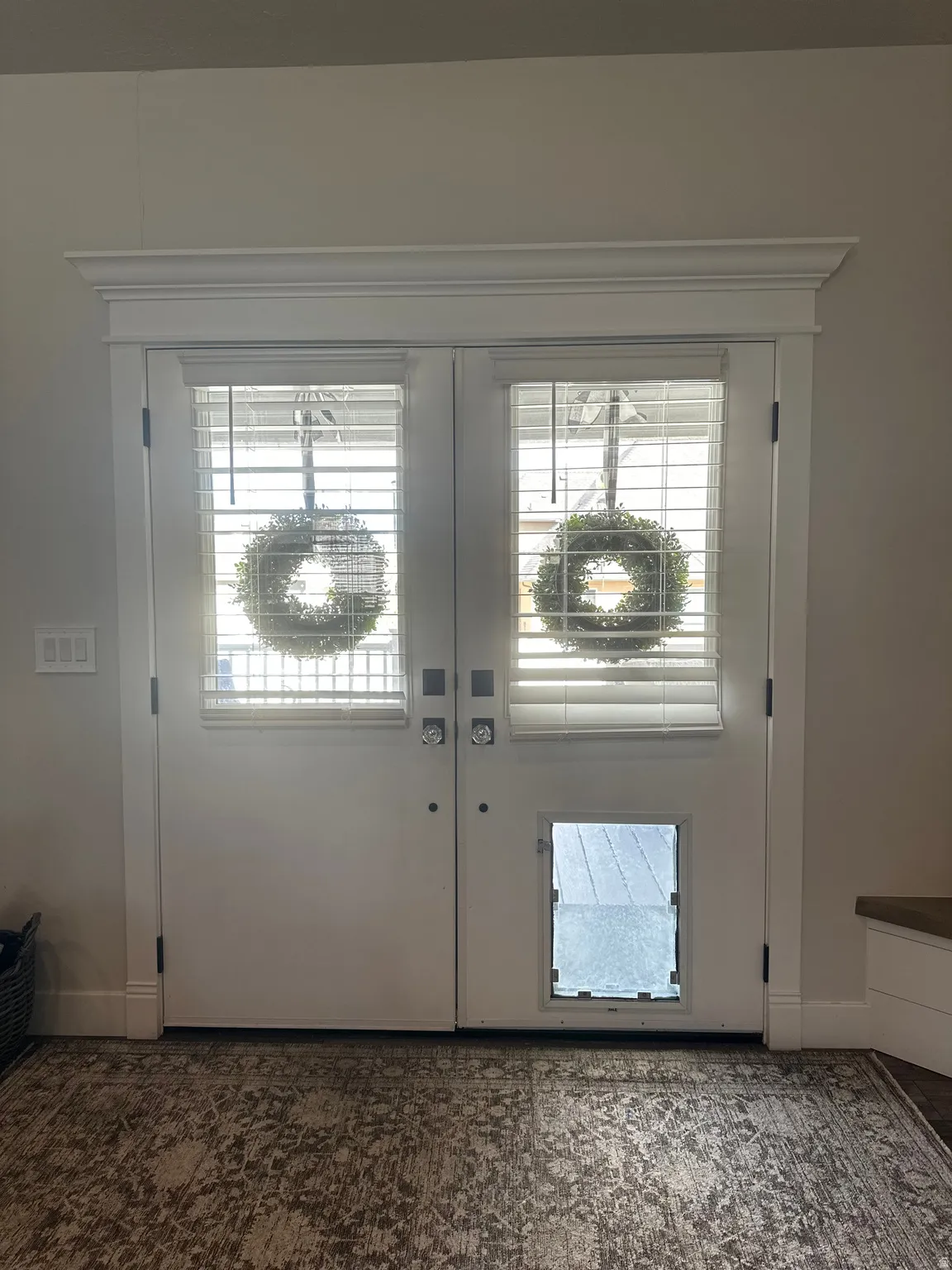 Doorway featuring baseboards and french doors