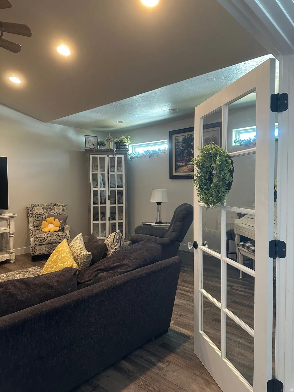 Living area with wood finished floors, recessed lighting, and a ceiling fan