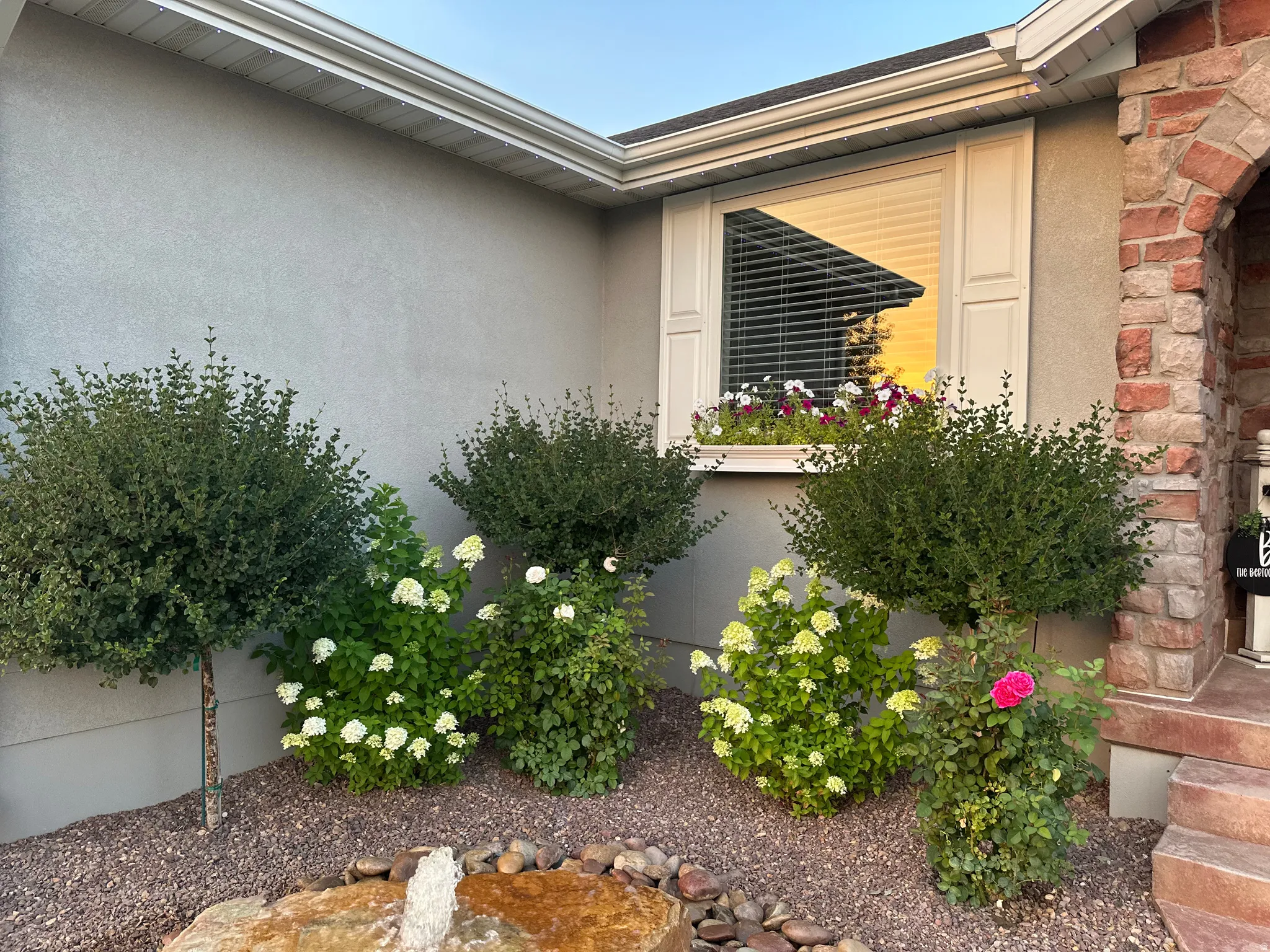 Entrance to property featuring stone siding and stucco siding