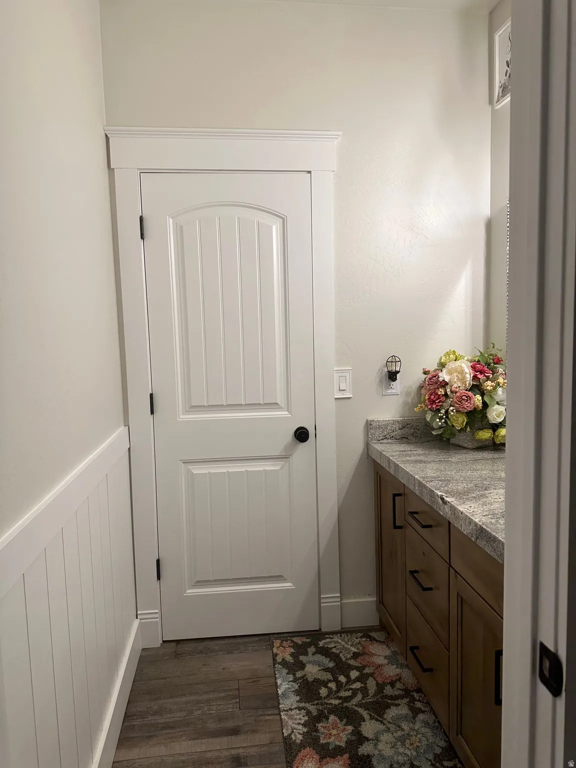 Bathroom with vanity, dark wood finished floors, and wainscoting
