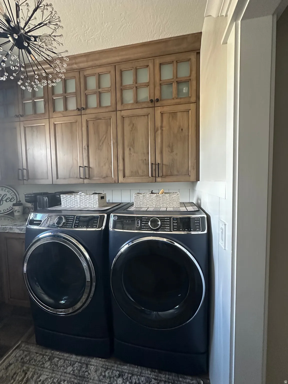 Laundry room featuring cabinet space and washing machine and clothes dryer