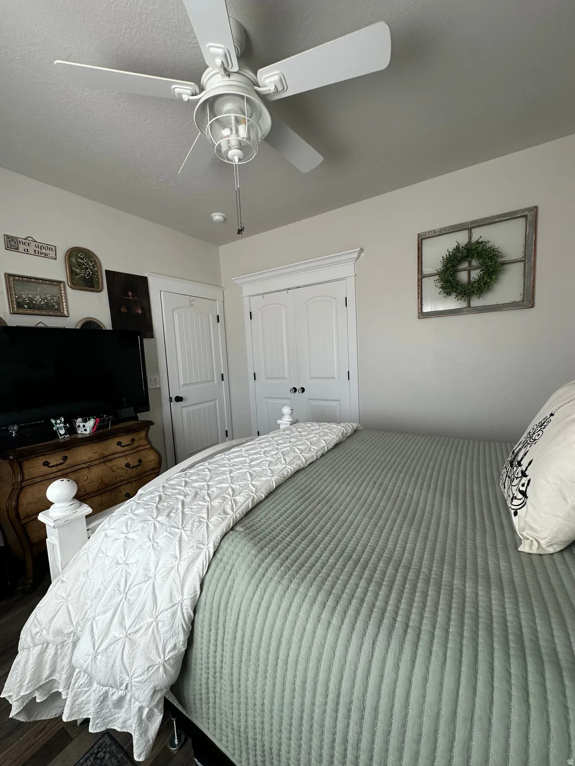 Bedroom with ceiling fan and a closet