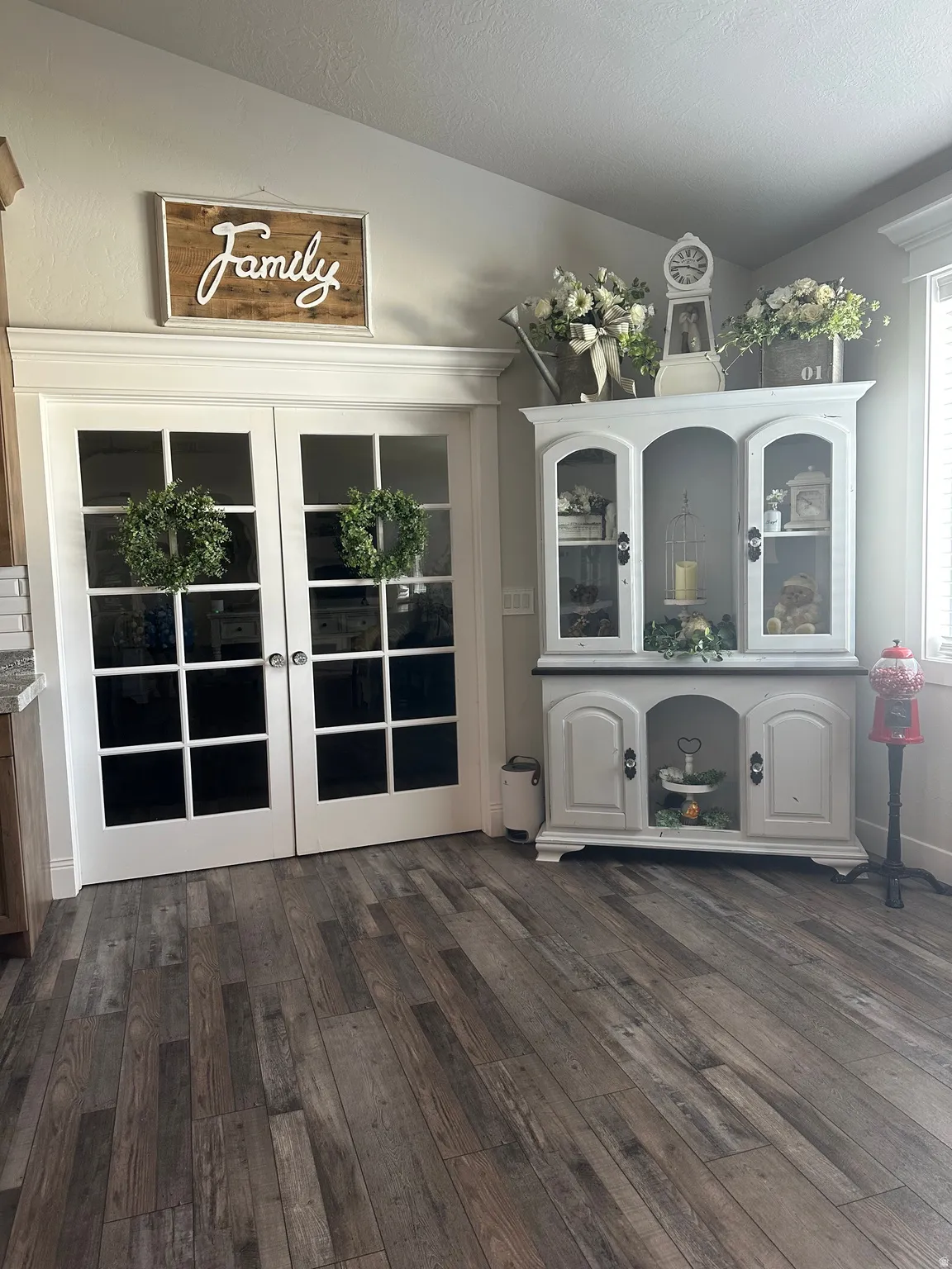 Unfurnished dining area with french doors, dark wood-style floors, and a textured ceiling