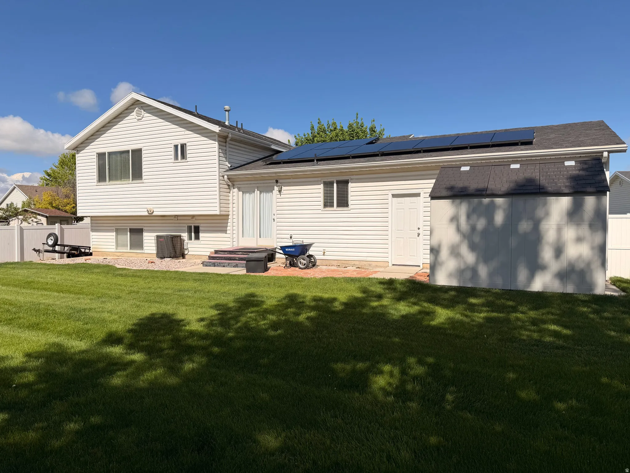 Rear view of property featuring solar panels