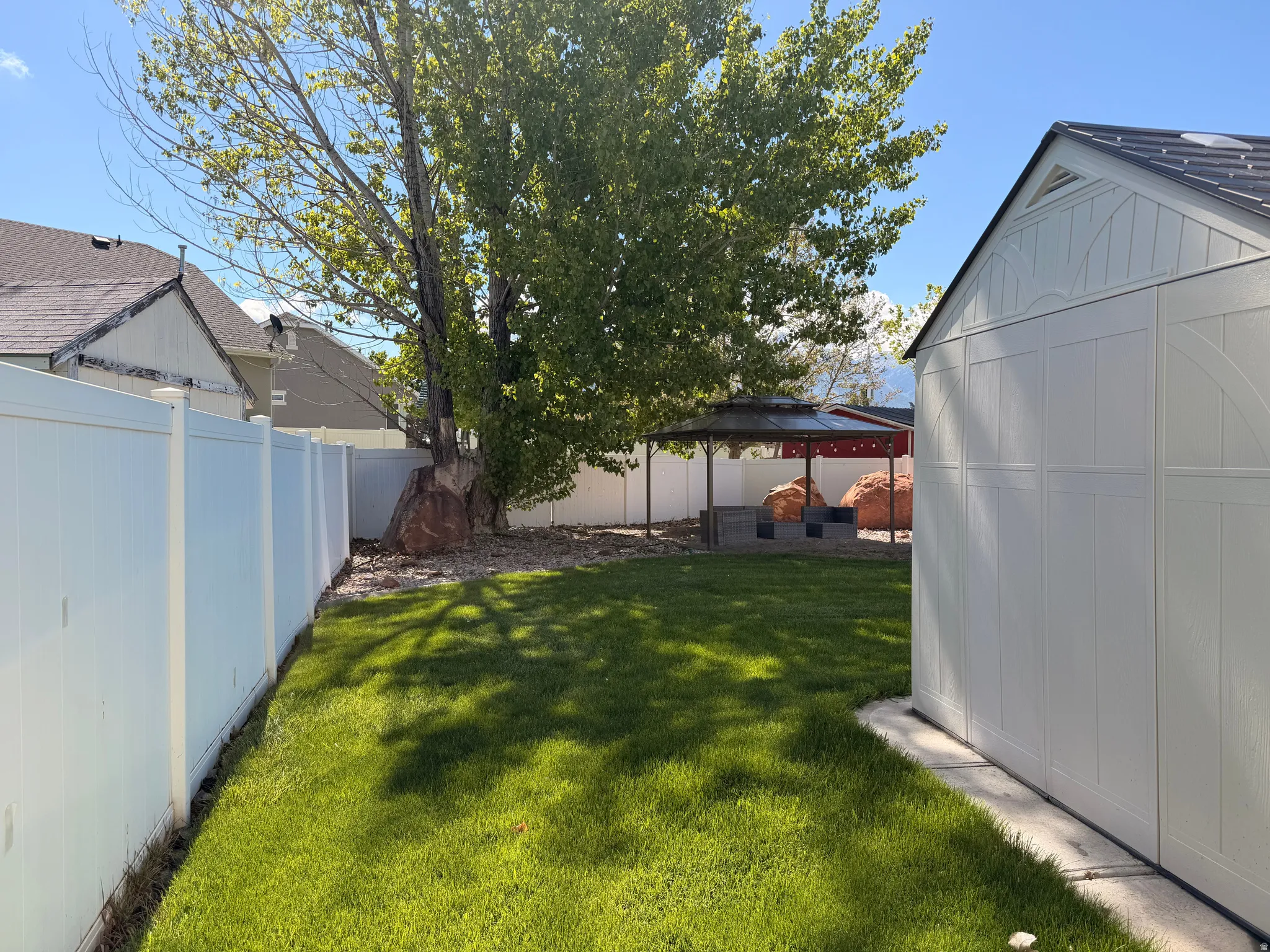 Fenced backyard with a gazebo
