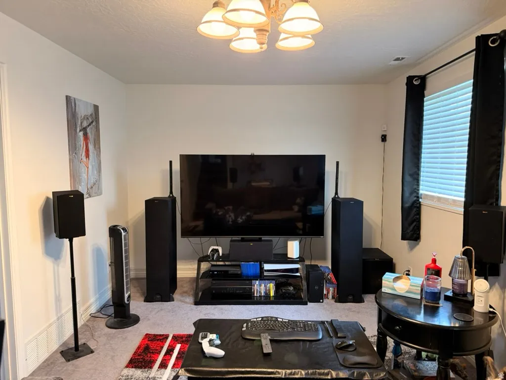 Living room with hanging lights and light carpet