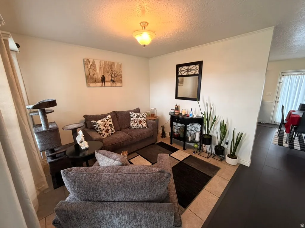 Tiled living area featuring a textured ceiling