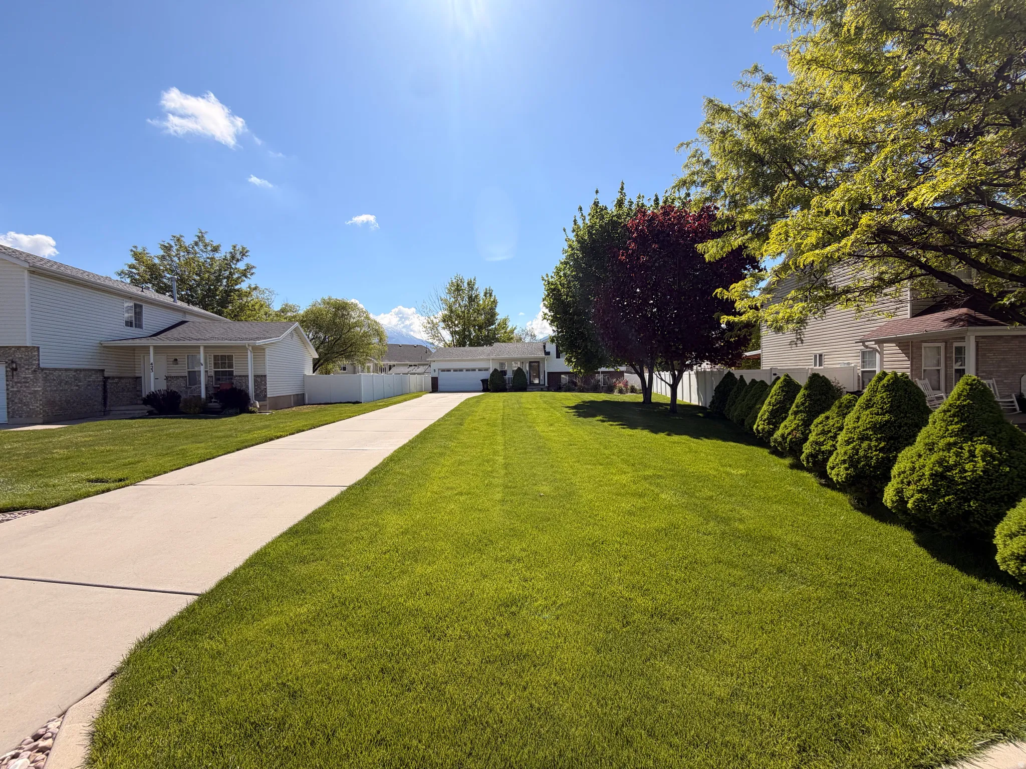 View of yard featuring a garage and concrete driveway