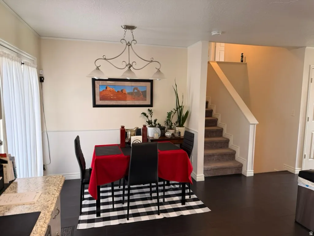 Dining room with dark wood-type flooring and a textured ceiling