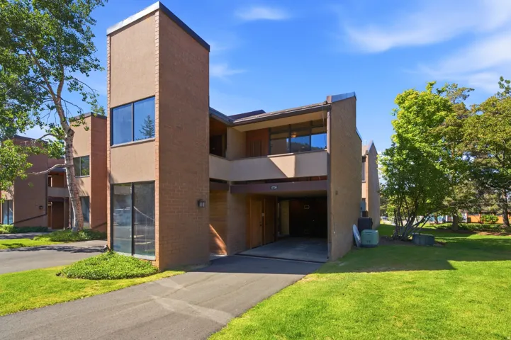 Modern multi-level exterior featuring a combination of brick and stucco finishes