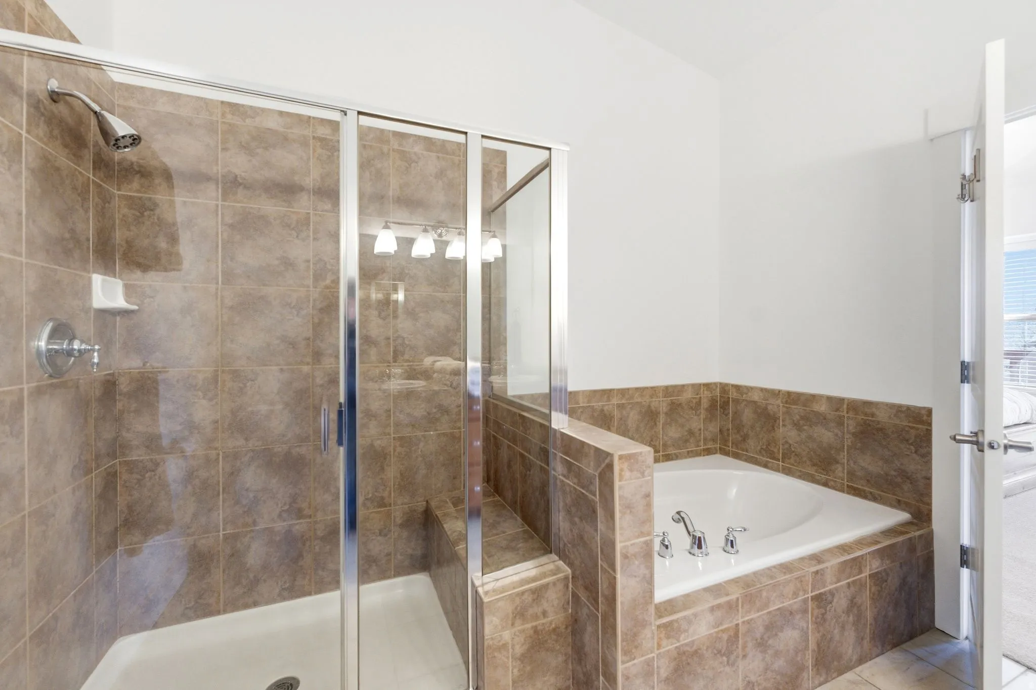 Bathroom with a stall shower and a bath