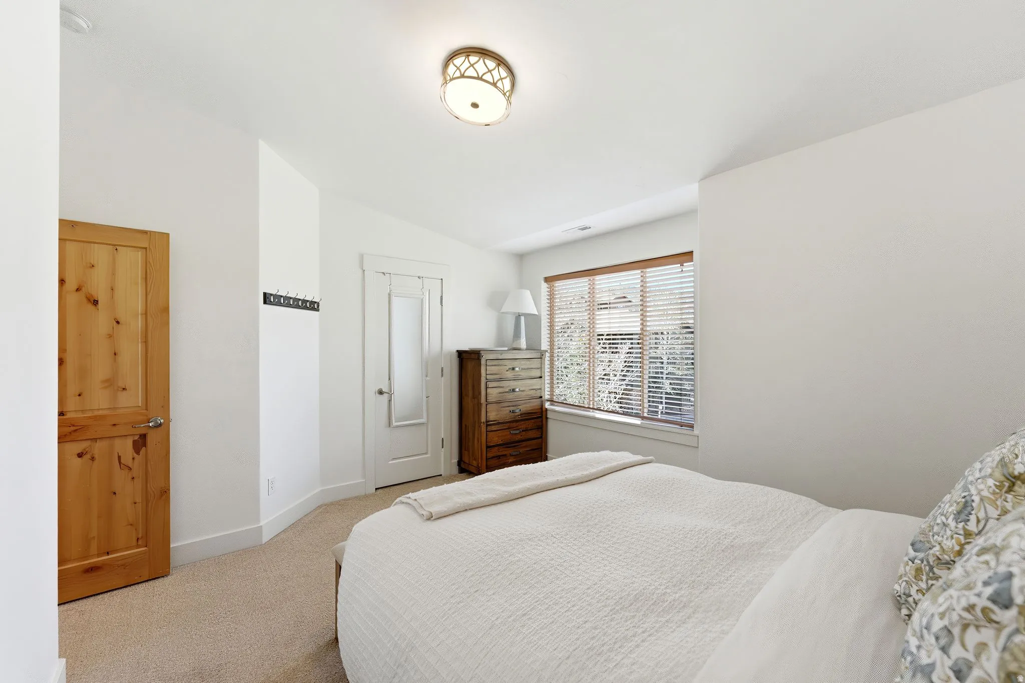 Bedroom with carpet flooring and lofted ceiling