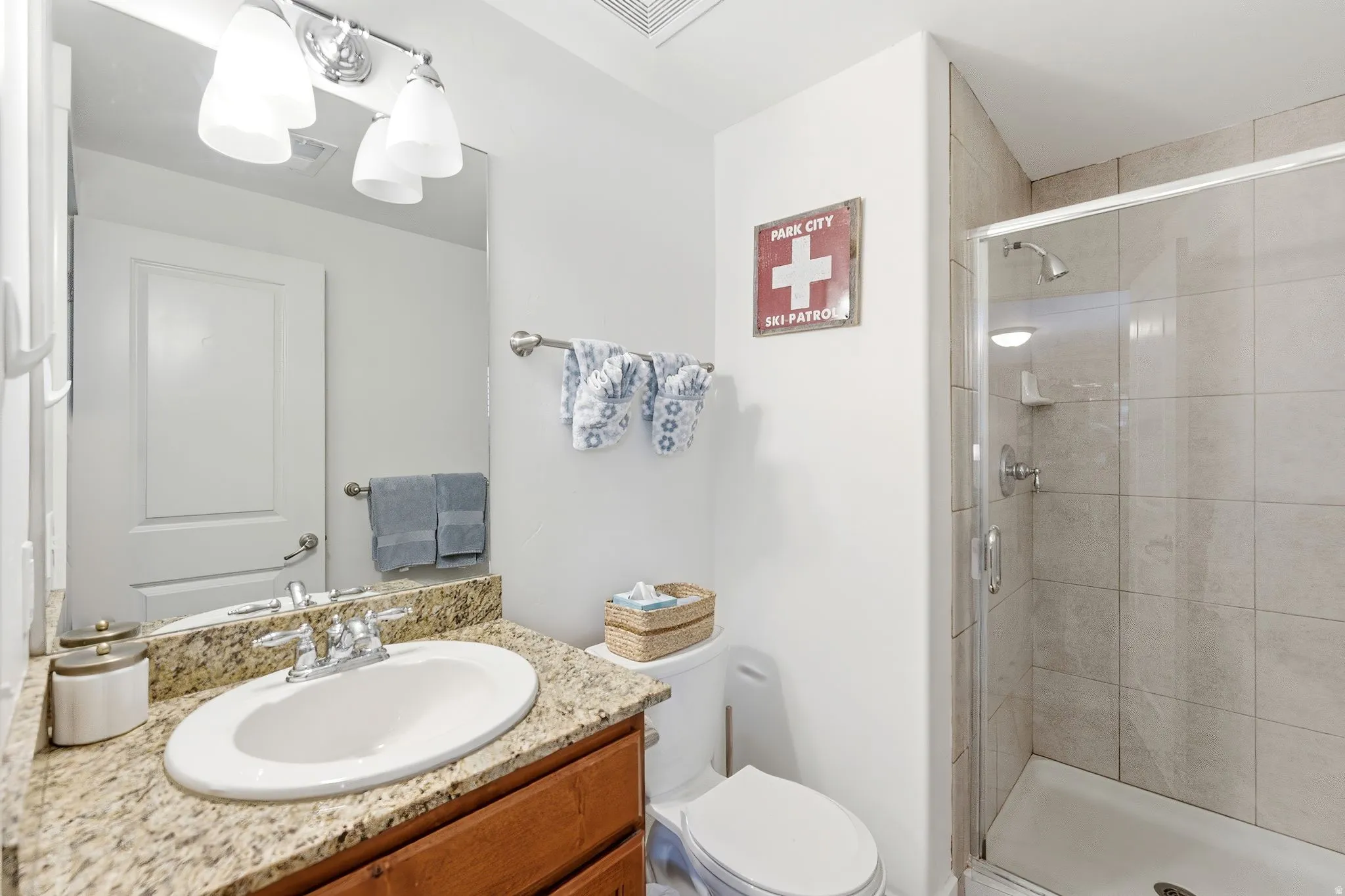 Bathroom with vanity and a shower stall