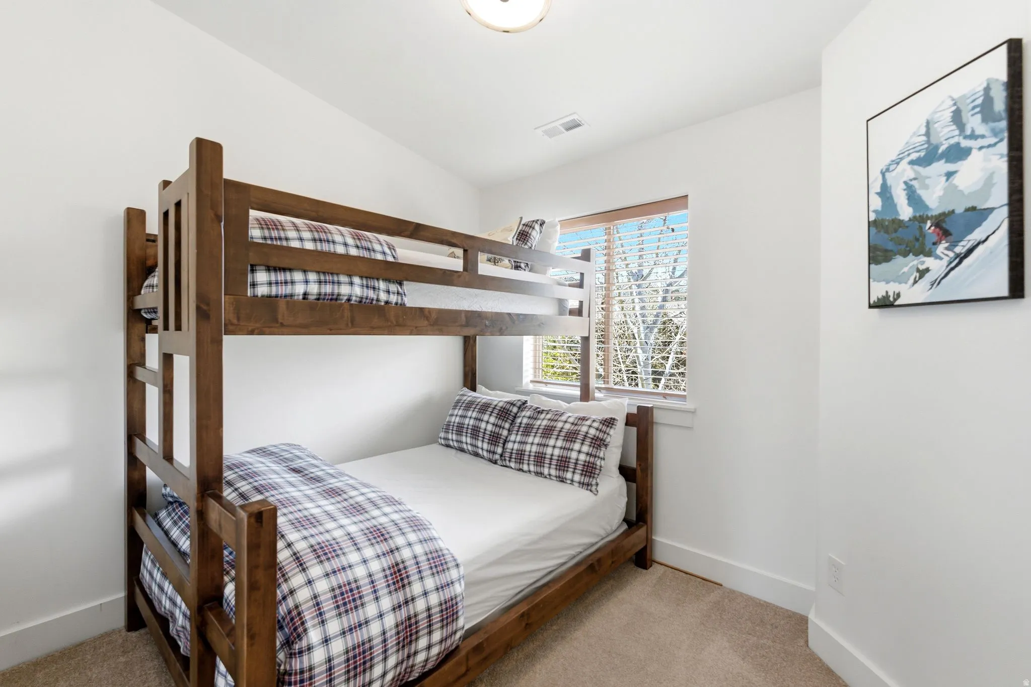 Bedroom featuring light colored carpet