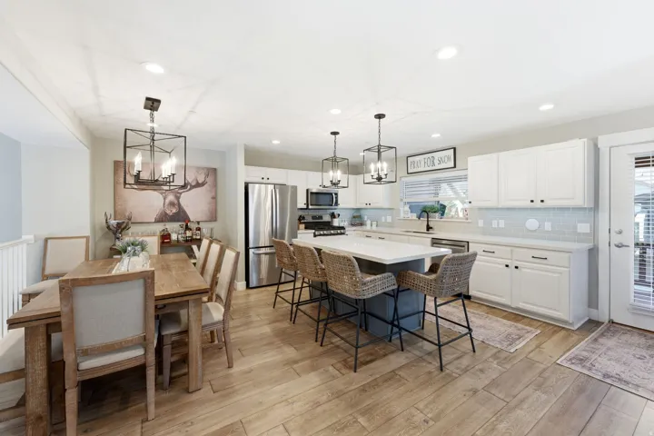 Dining space featuring suspended lighting and light wood-style floors