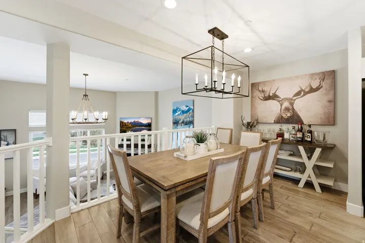 Dining area with hanging lights and light wood-style floors