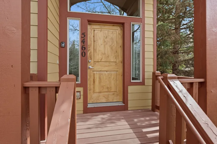 Doorway to property with a wooden deck
