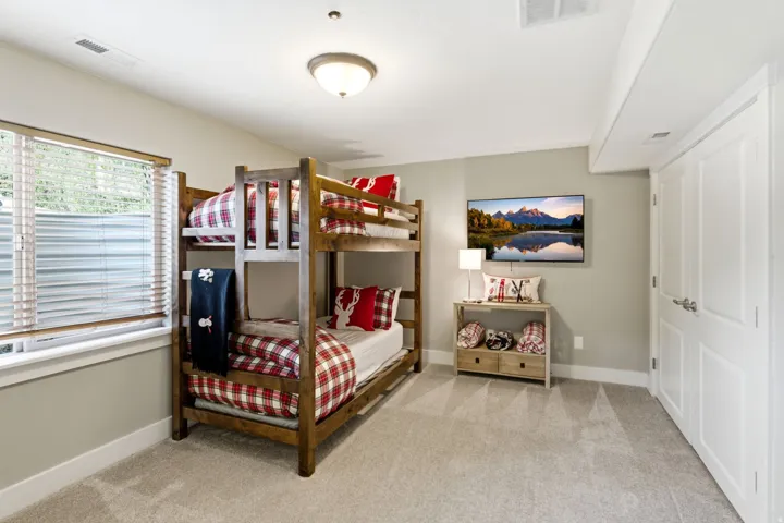 Bedroom with light carpet and baseboards