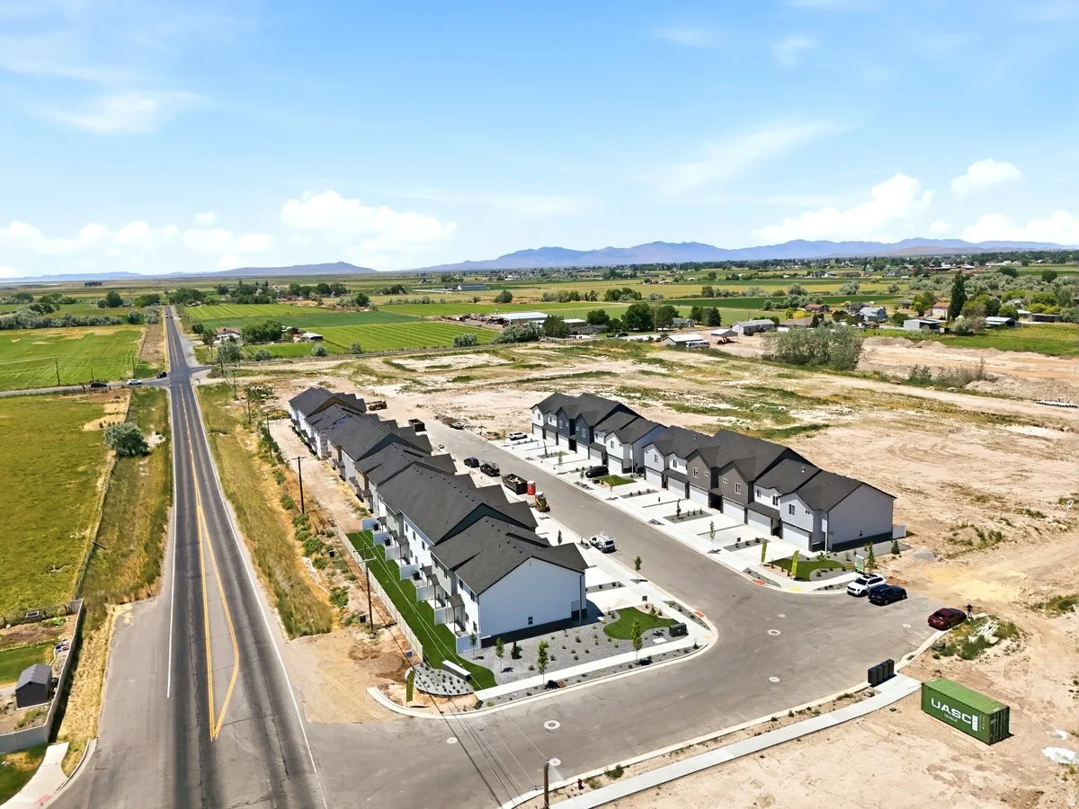 Newly constructed townhome community featuring modern architectural design and dark-toned roofing