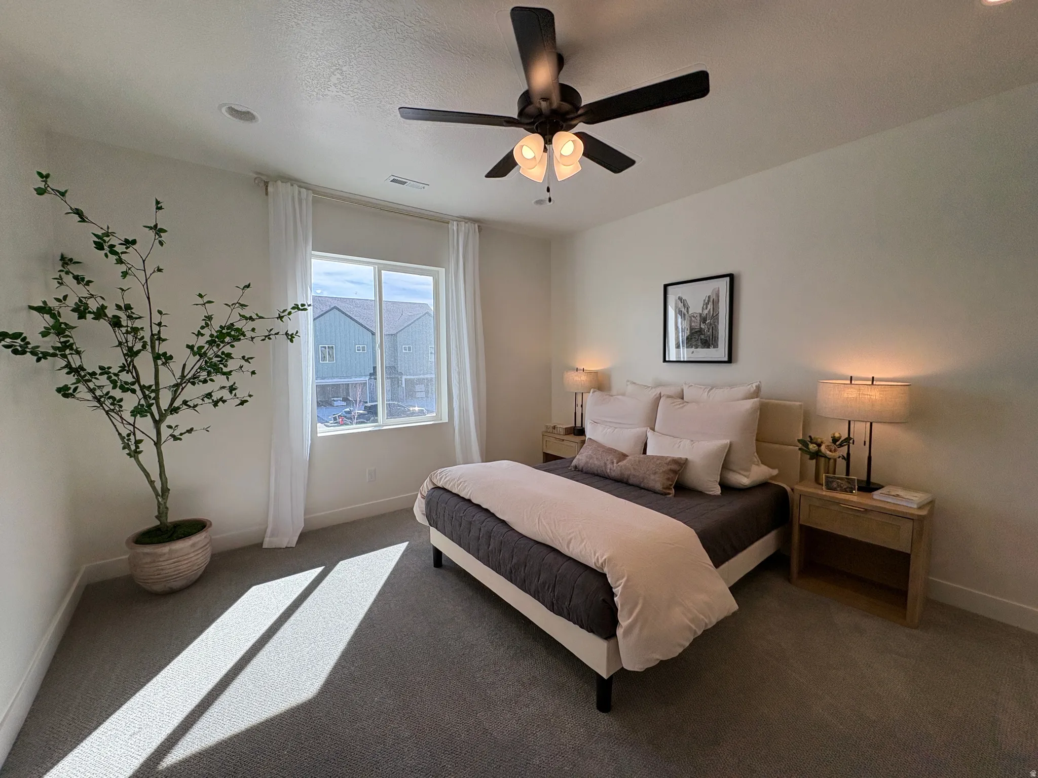 Bedroom with ceiling fan and carpet flooring