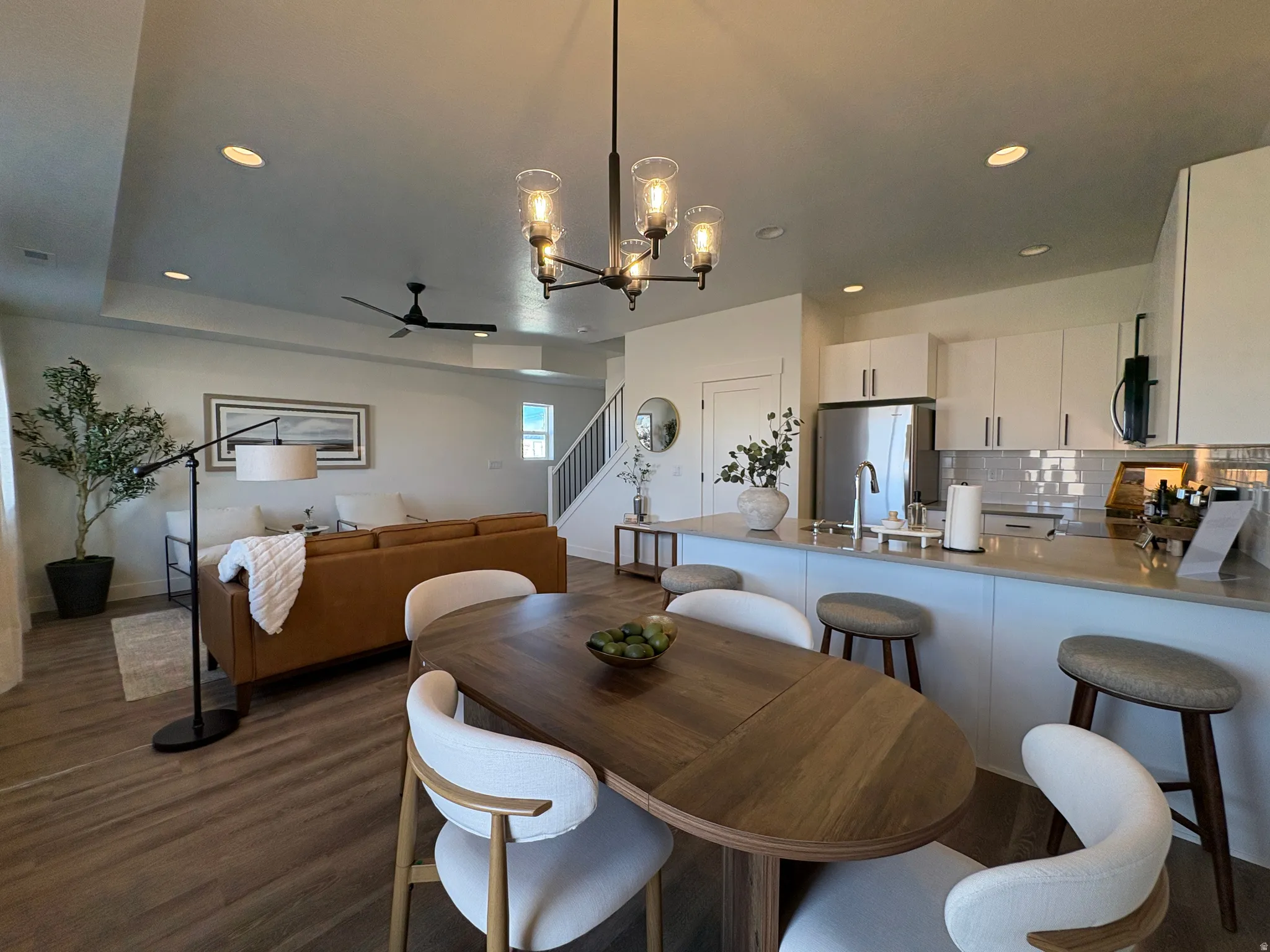 Dining room featuring hanging lights, dark wood-style flooring, and a ceiling fan