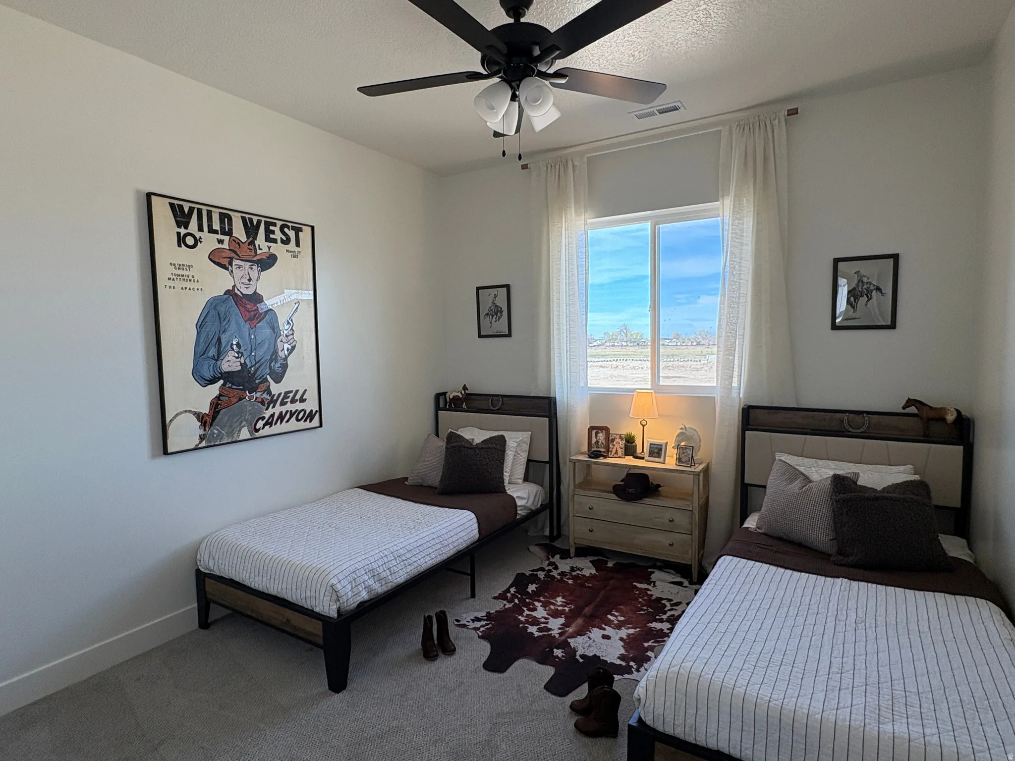 Carpeted bedroom with ceiling fan and baseboards