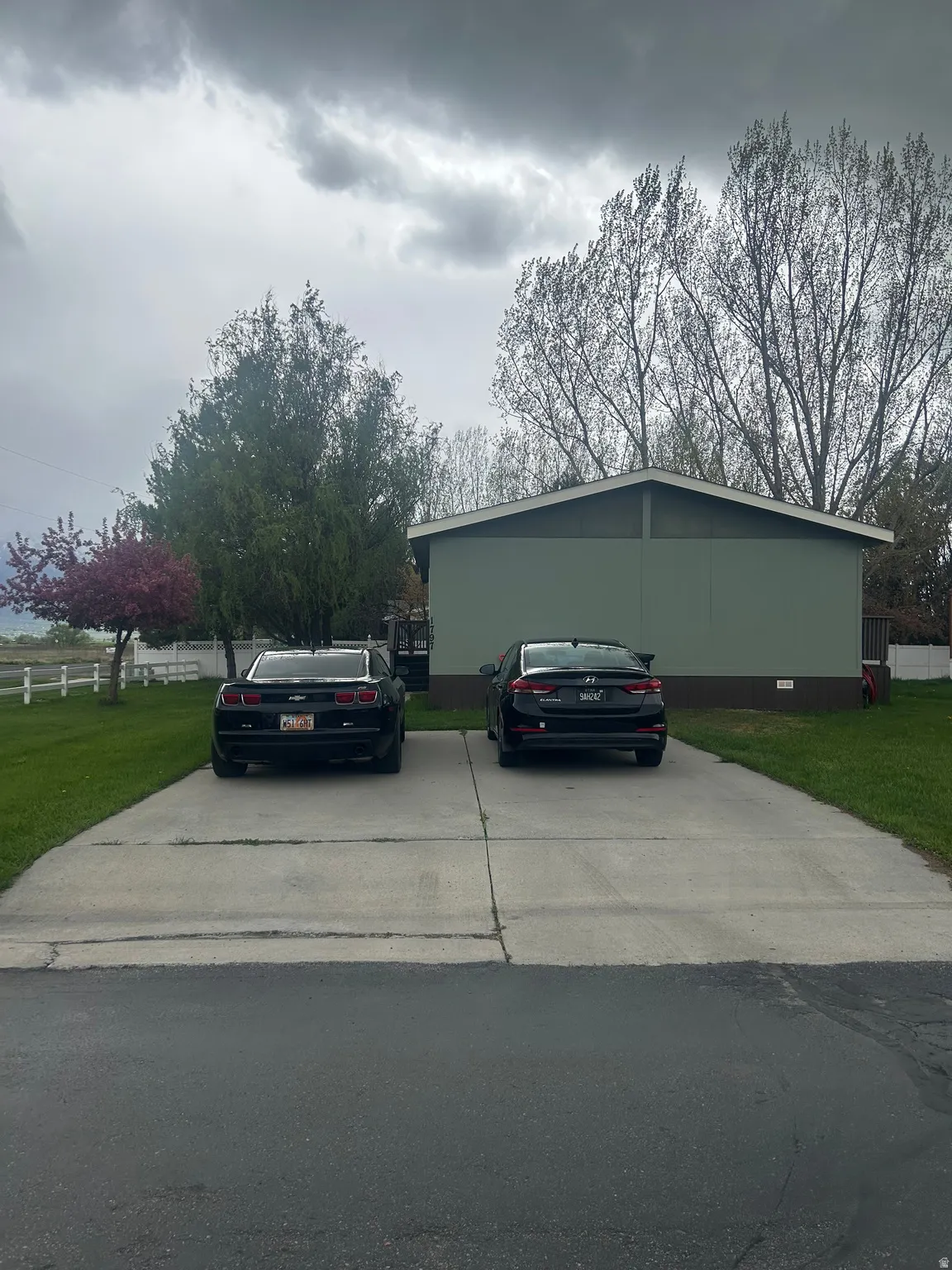 View of side of property with a lawn