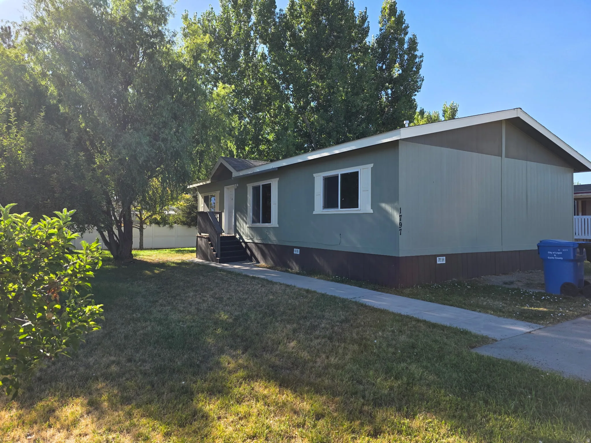 View of property exterior with a lawn