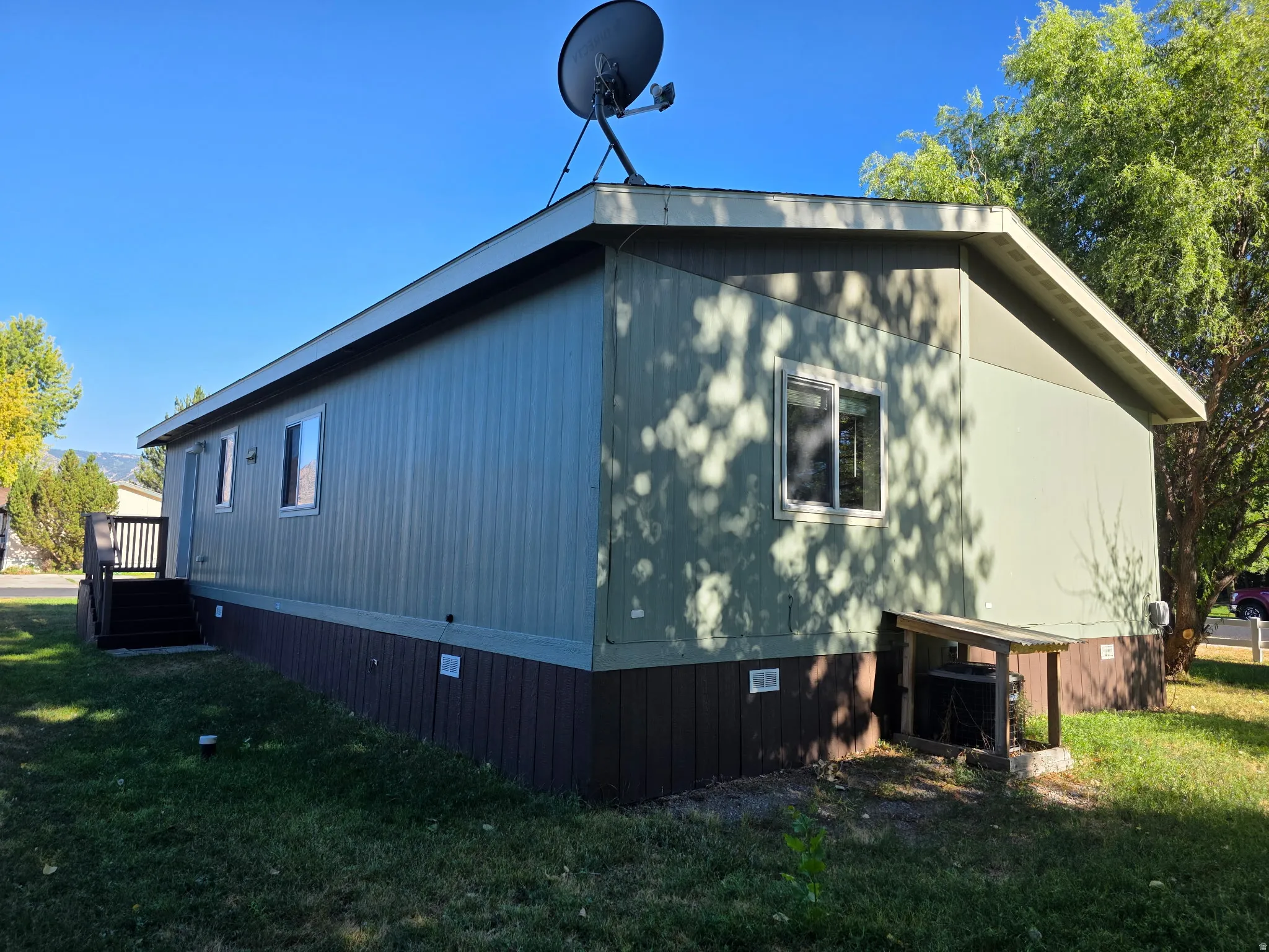 View of property exterior with crawl space and a lawn