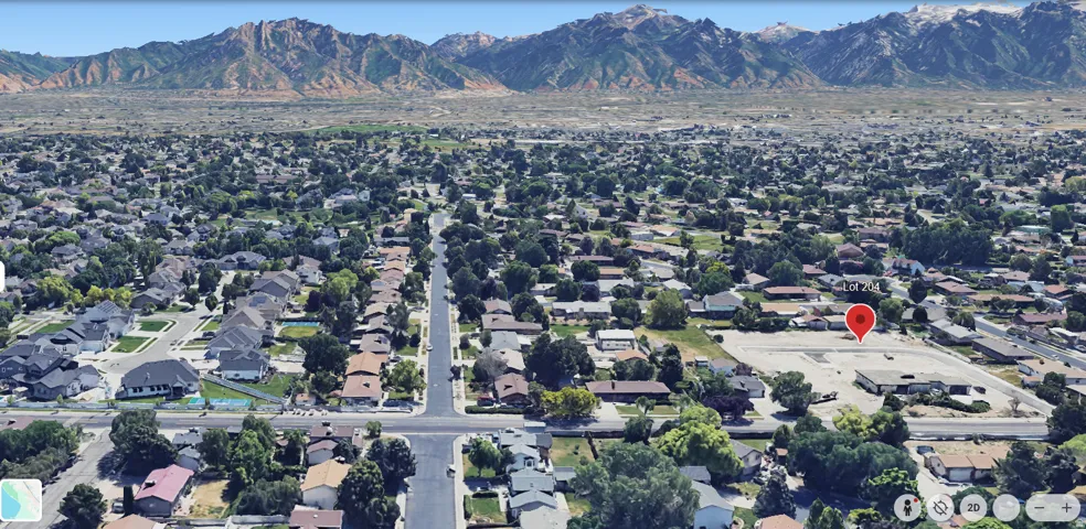 Aerial overview of property's location featuring nearby suburban area and mountains