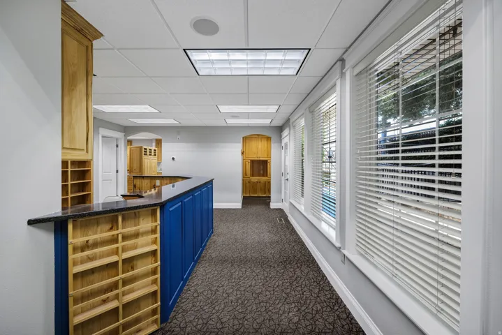 Reception area with arched walkways and a paneled ceiling