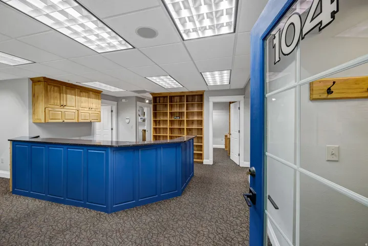 Reception area featuring a paneled ceiling and dark colored carpet