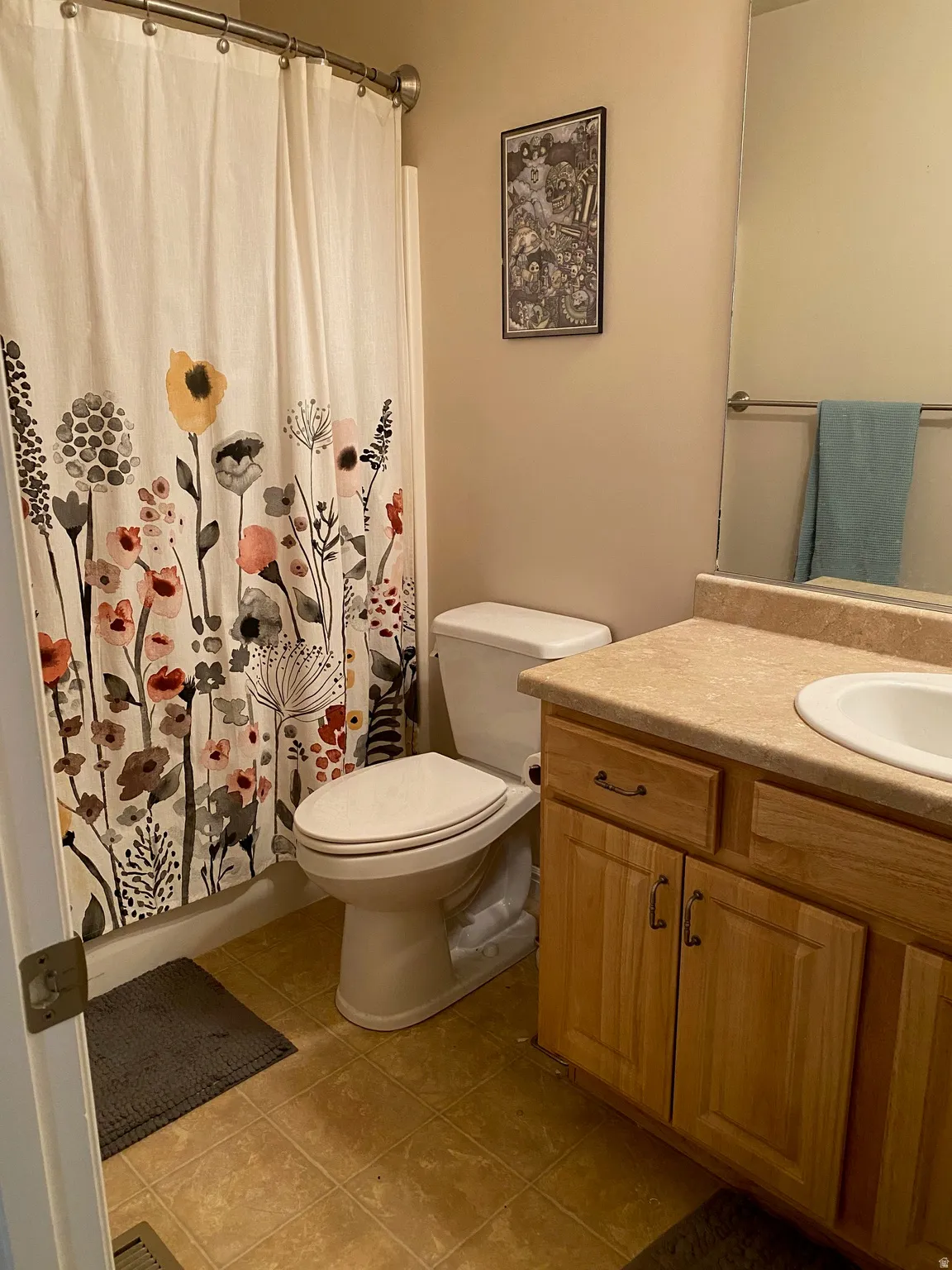 Bathroom with vanity, a shower with curtain, and light tile patterned floors