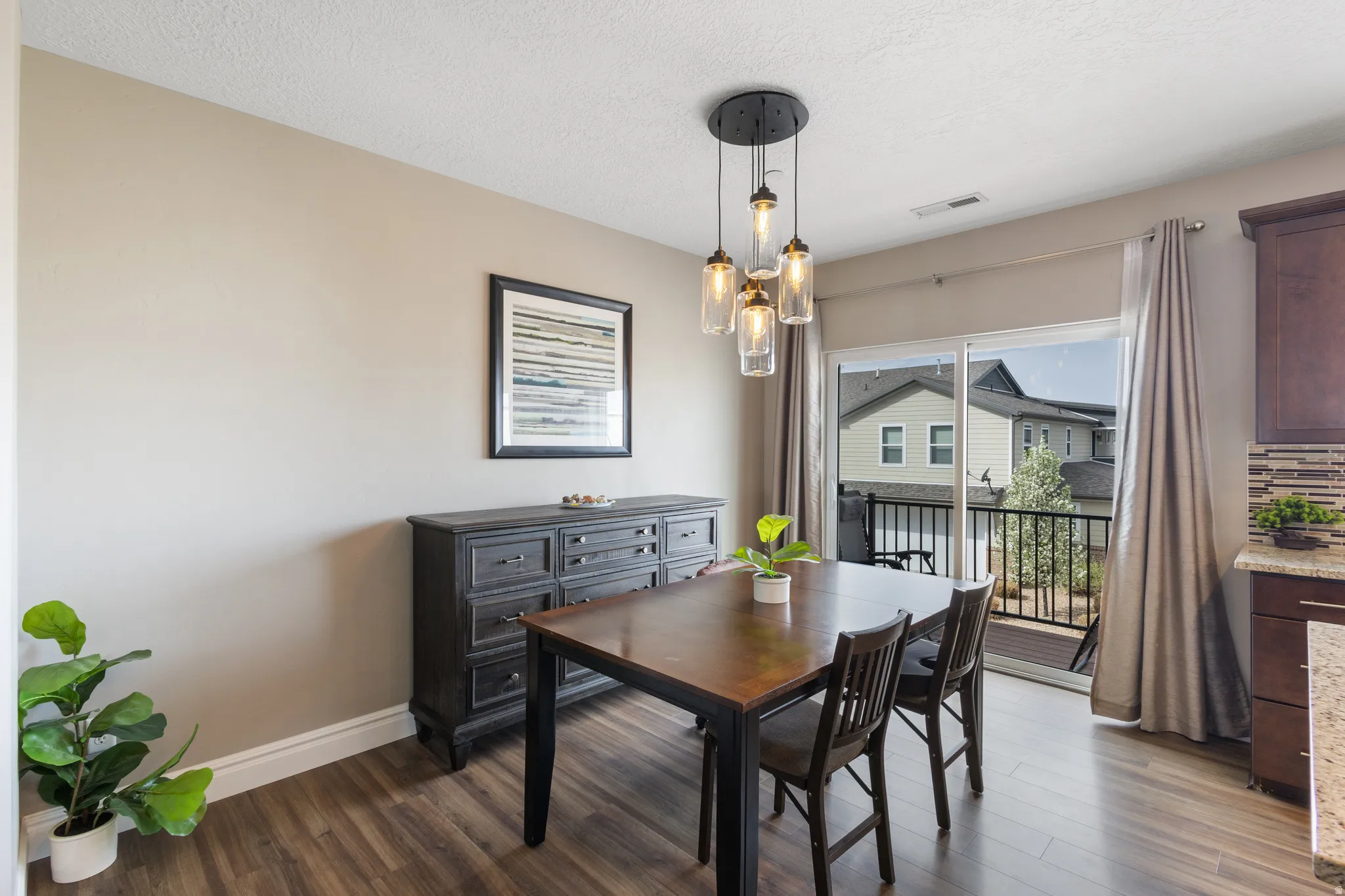 Dining room with dark wood finished floors and a textured ceiling