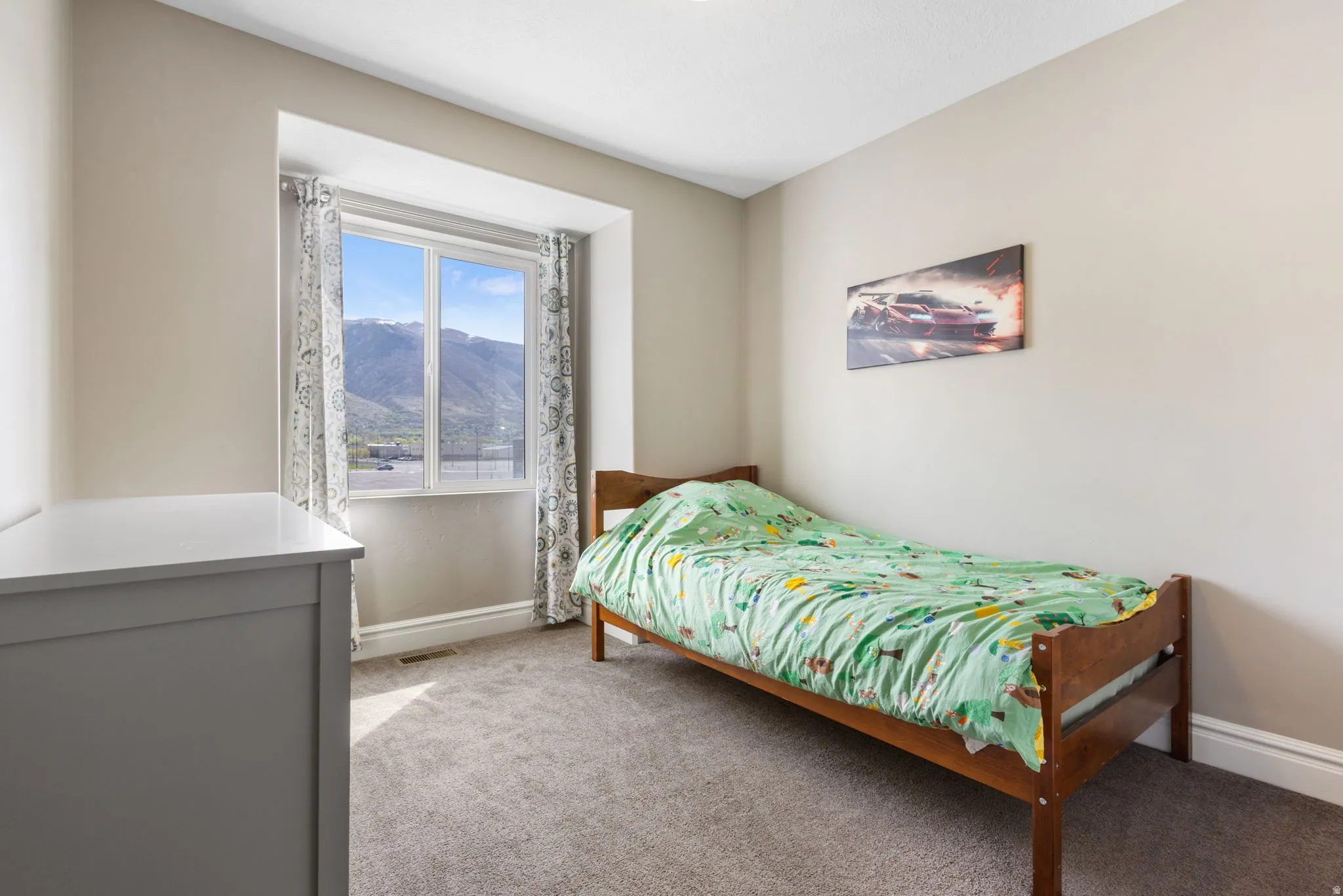 Bedroom featuring light colored carpet and a mountain view