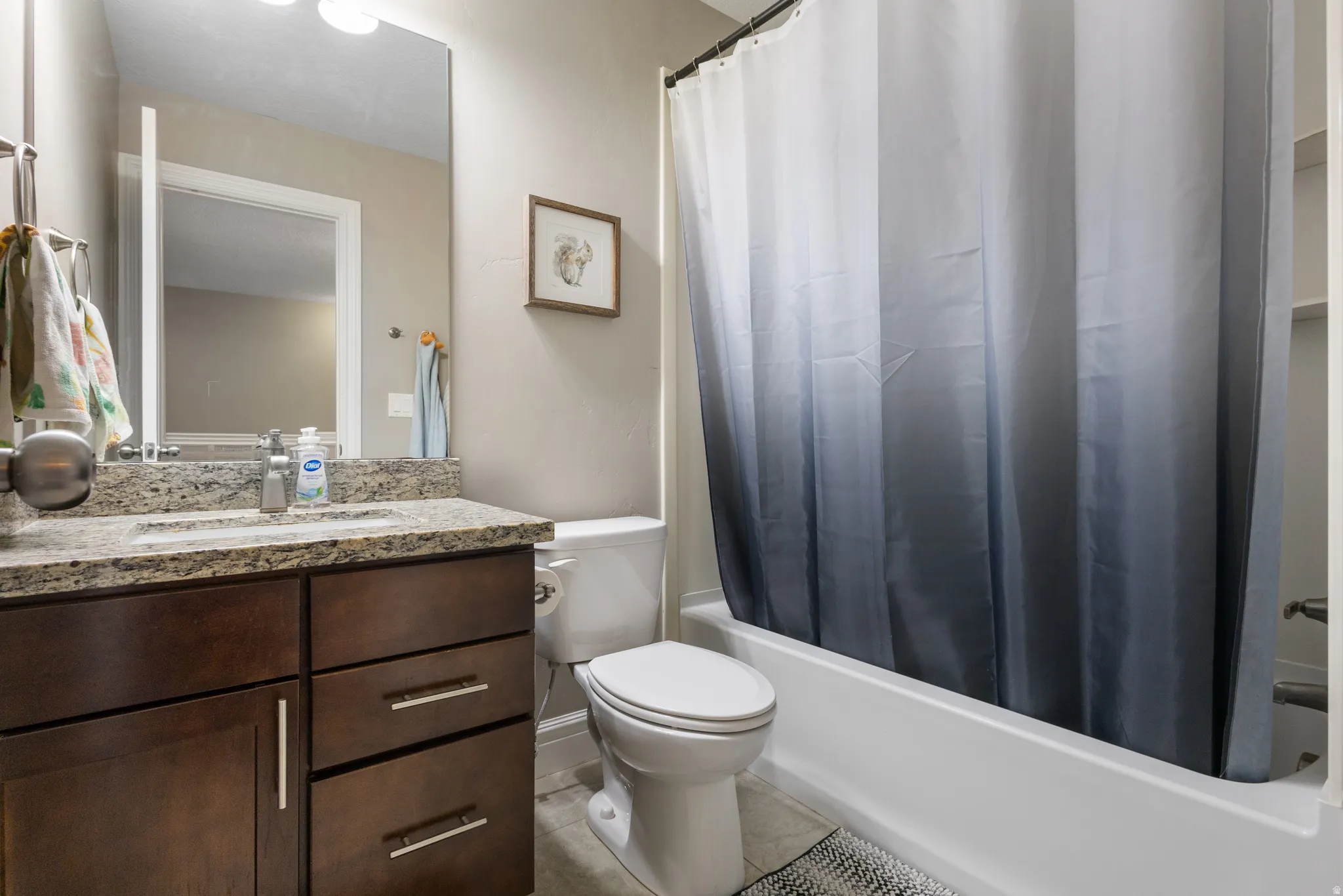 Bathroom with vanity, light tile patterned flooring, and shower / bath combo