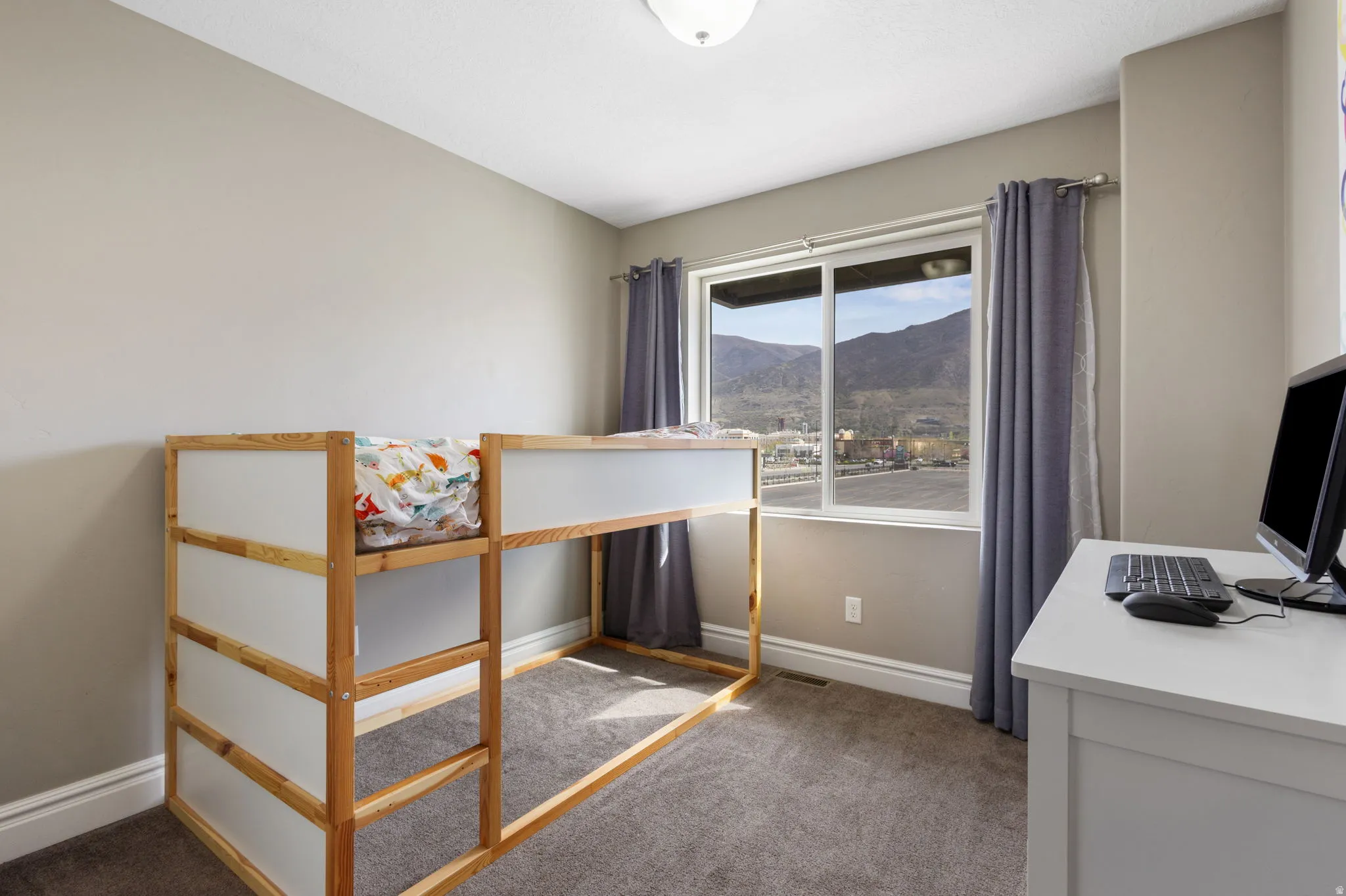 Unfurnished bedroom with carpet and a desk