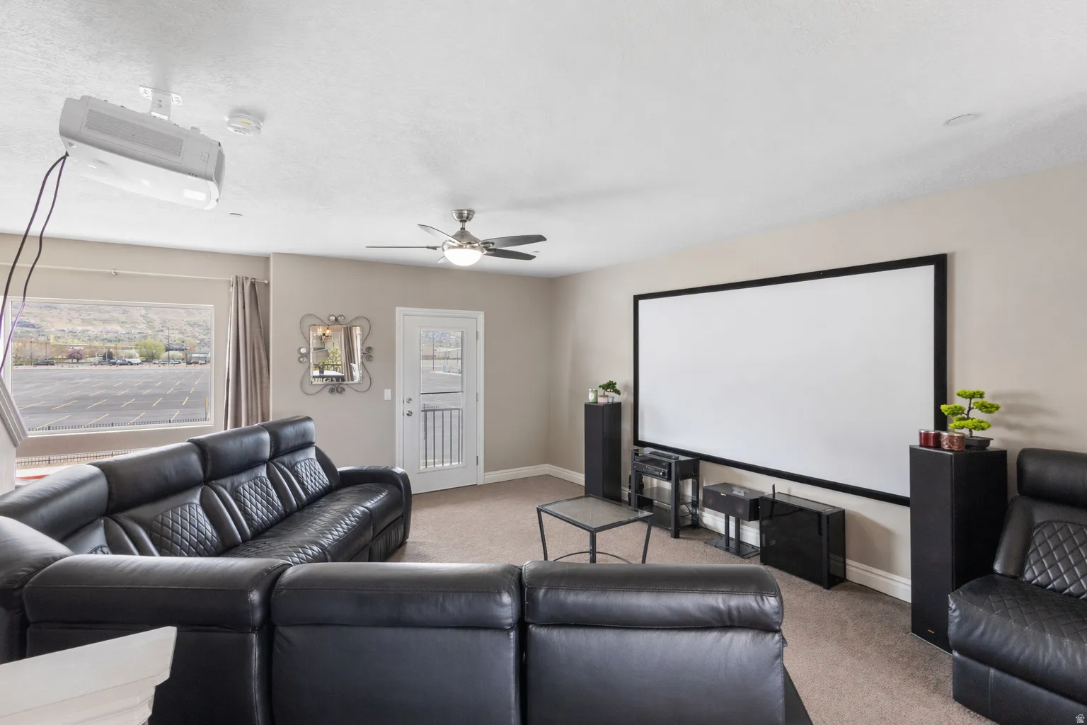 Living room with light colored carpet and a ceiling fan