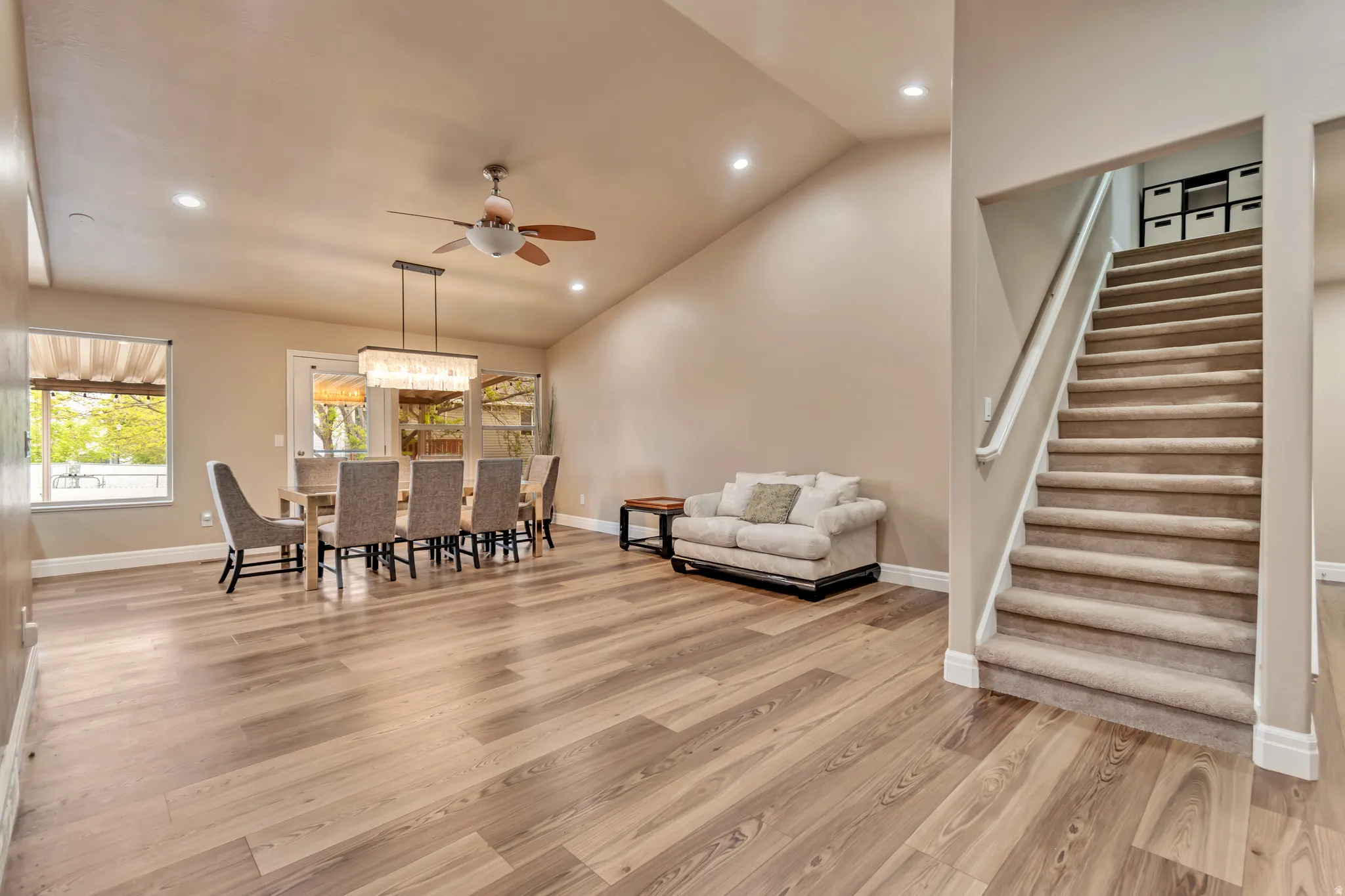 Dining room featuring a beautiful light fixture above kitchen table.  This space is bright, open and inviting.