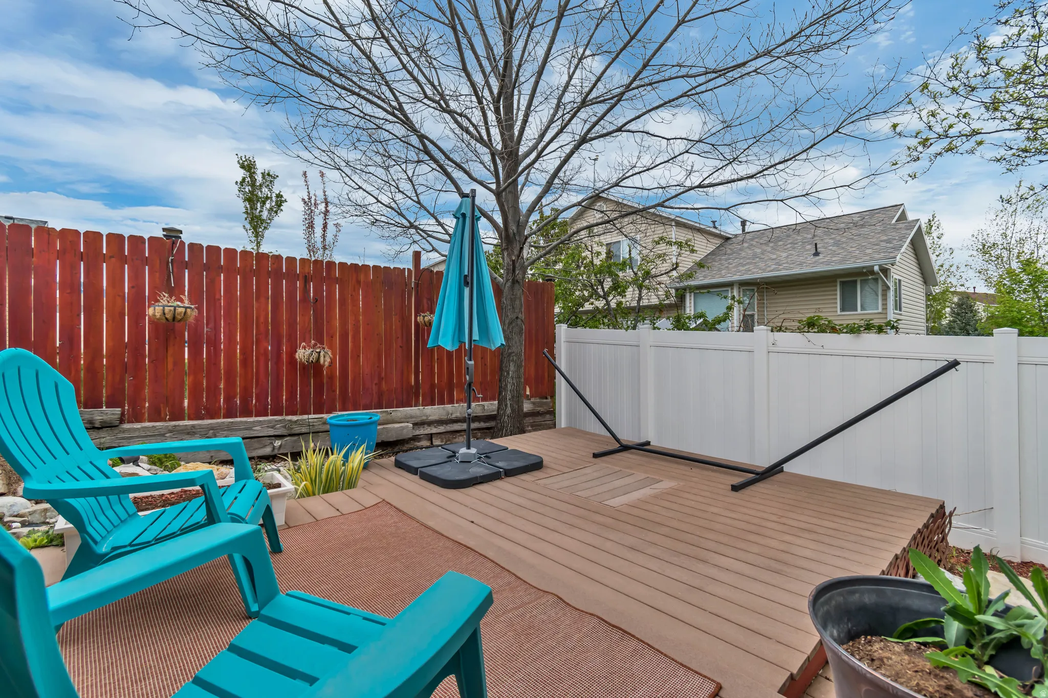 Deck with a fenced backyard. Please note the square in the center of the deck was once used as a fire pit.  This can be removed to install your new fire pit.