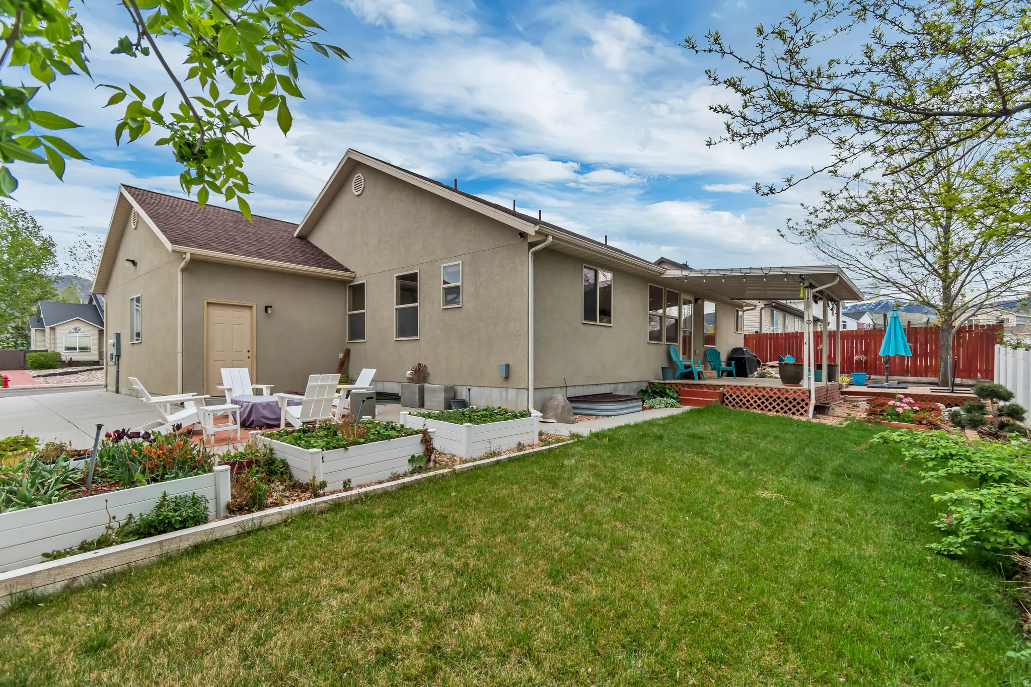 Great view from the northwest corner of the property.  See the quality stucco siding, raised planter boxes (with drip irrigation) and three-tiered patio.